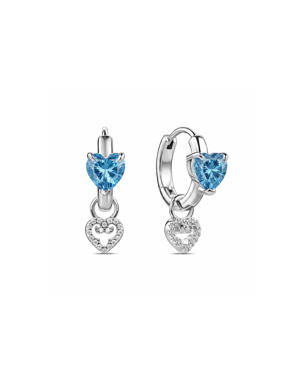 A pair of silver huggie hoop earrings featuring a heart-shaped light blue gemstone and a dangling heart-shaped crystal cluster, shown on a plain white background.