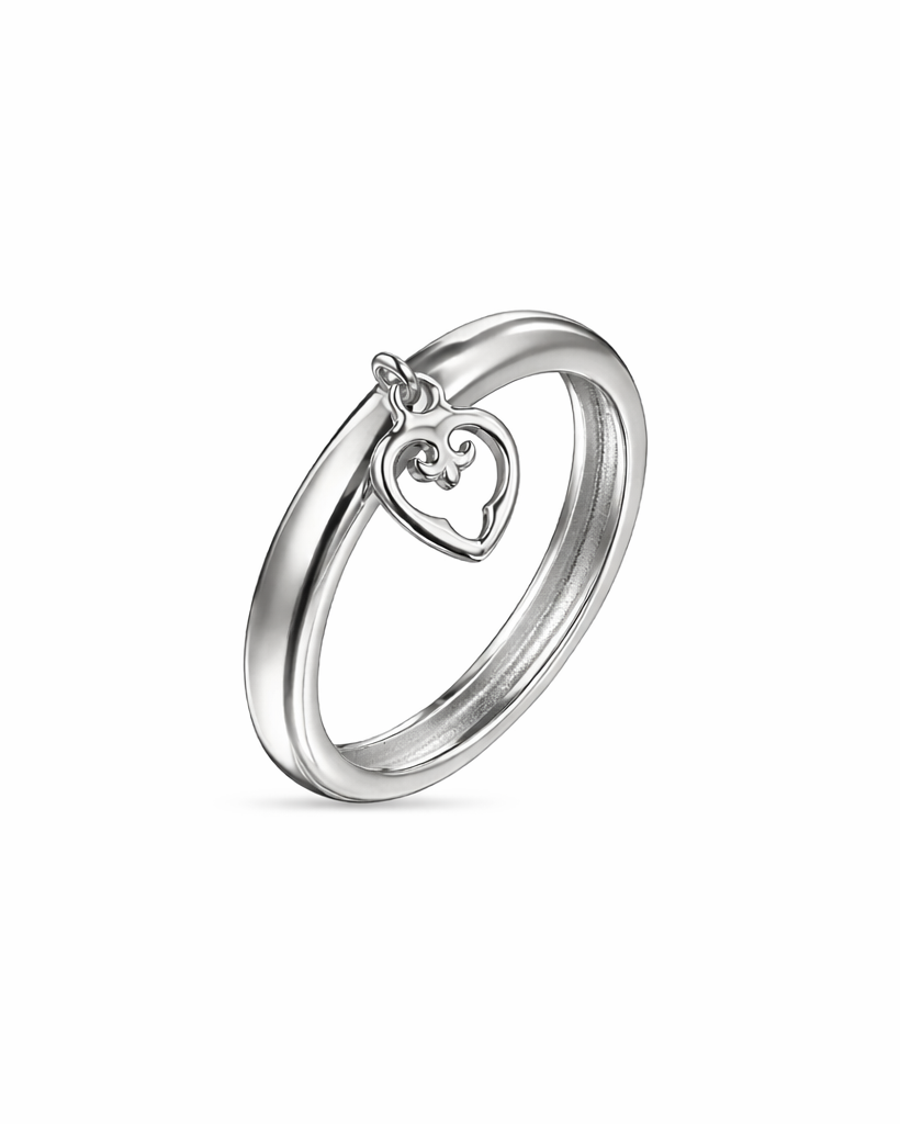 Silver ring with a heart-shaped charm on a white background